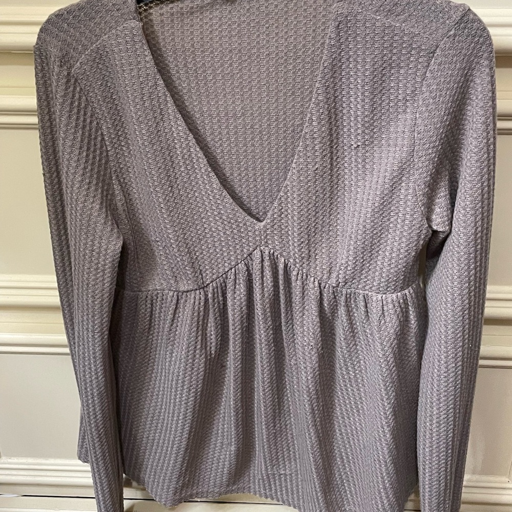 Taupe colored v neck thermal blouse. Elastic bra line